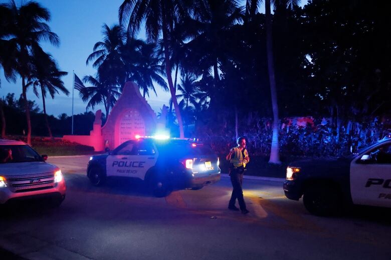 Supporters of Trump stand outside his Mar-a-Lago home after Trump said that FBI agents raided it, in Palm Beach, Fla., on Aug. 8.