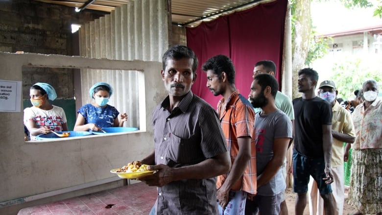 People line up for food.