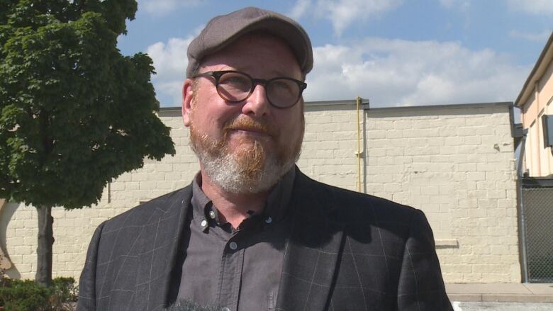 Mayoral candidate Chris Holt speaks to reporters outside the Windsor Arena, sharing his proposal for the building and surrounding neighbourhood.