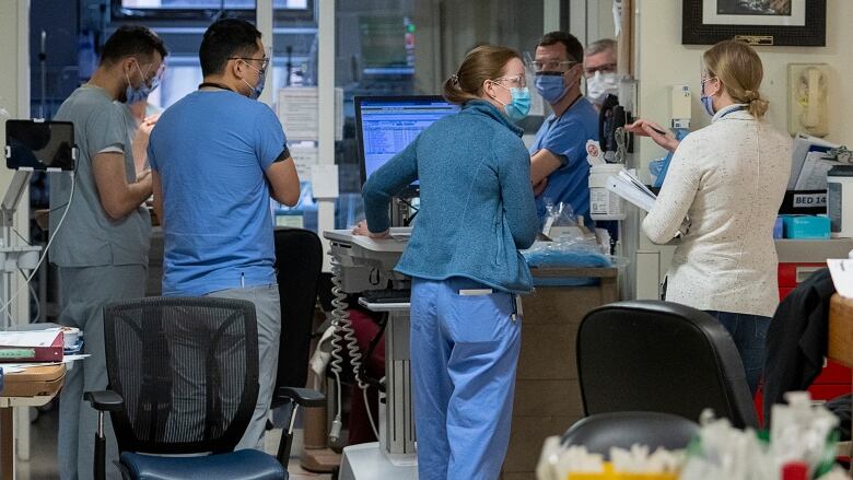 Doctors and nurses meet in a hospital.