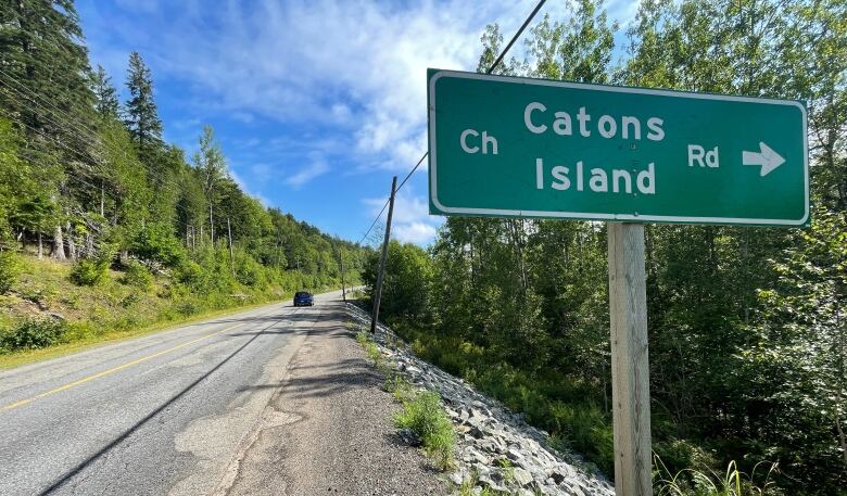 A green government road sign.