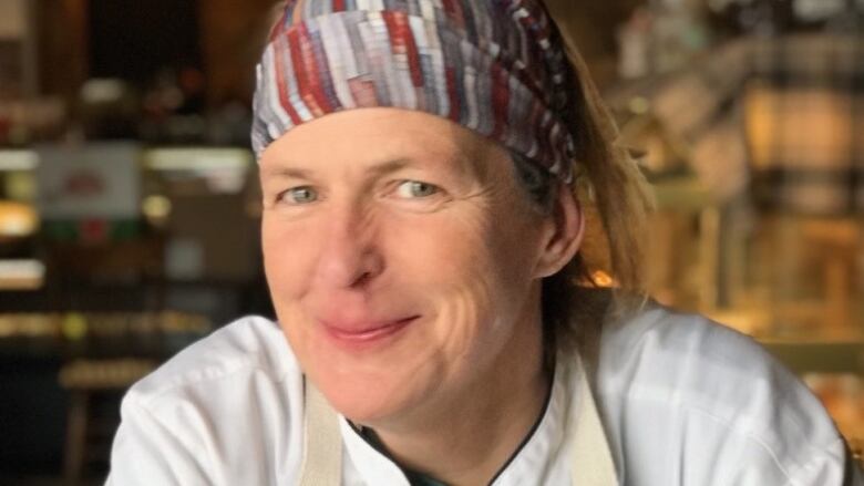 A female chef poses for a photo.