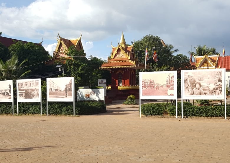 A series of pictures on hoardings near a shrine.