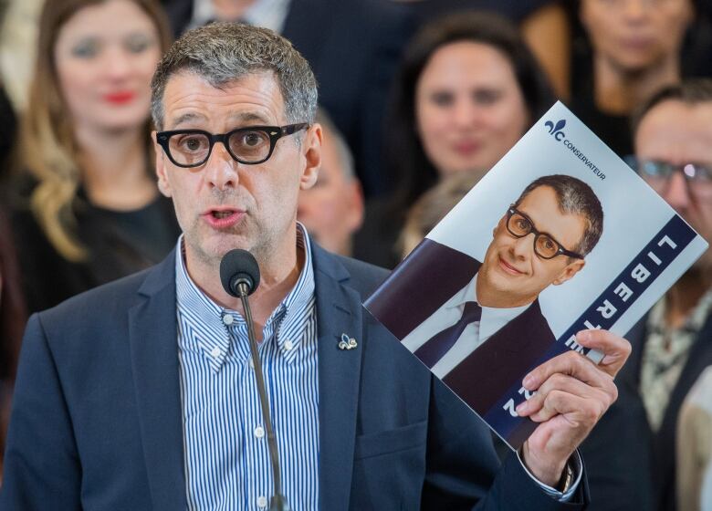 A man is holding a book