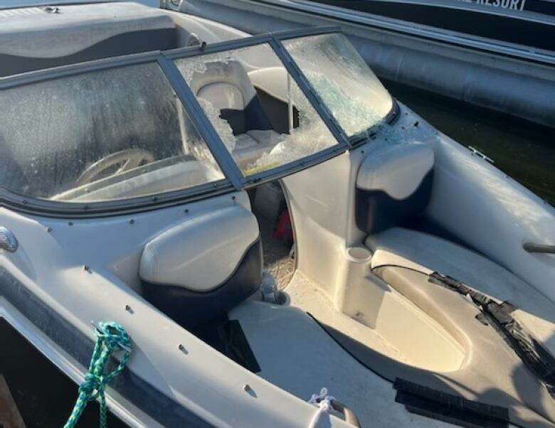 A boat's windshield, the middle pane of which has been shattered by hailstones. 