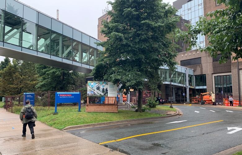 A person walks by a hospital.