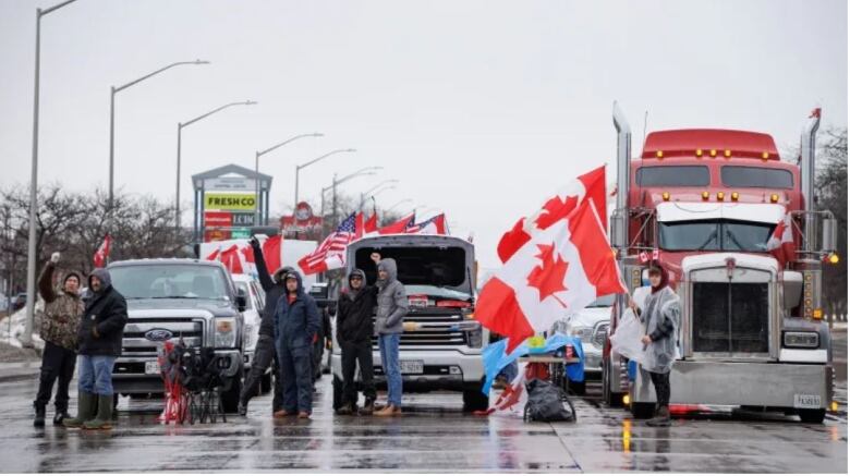 A group of protestors and trucks block Huron Church Road and access to the Ambassador Bridge in February.