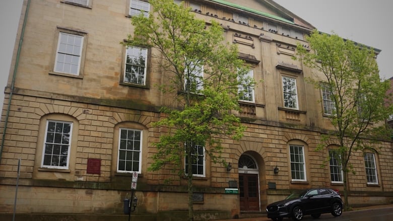 Large, old building pictured with camera looking up.