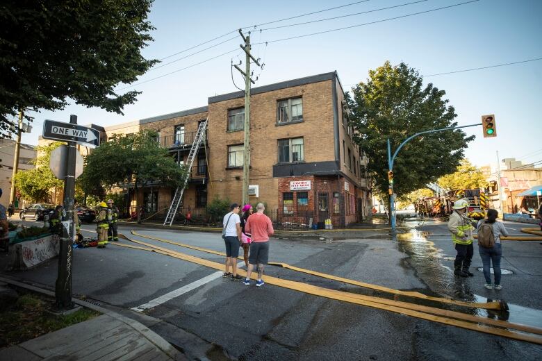 Fire crews are pictured on scene of a fire at an apartment near Princess and Powell in Vancouver, British Columbia on Monday, August 22, 2022. 