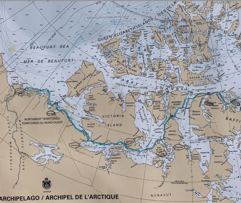 A blue line winds its way across a map, between islands, showing a kayaking route.