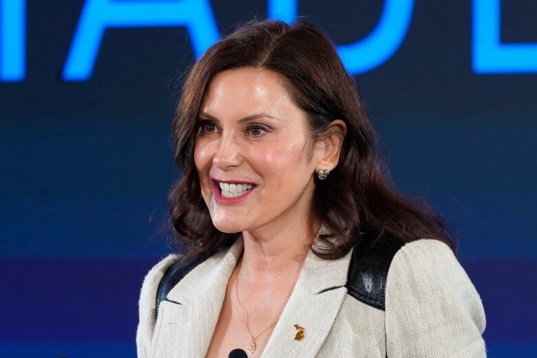 A woman speaks at a podium.