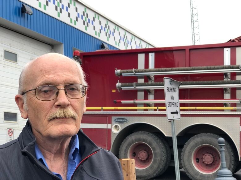 Man in front of a fire engine. 