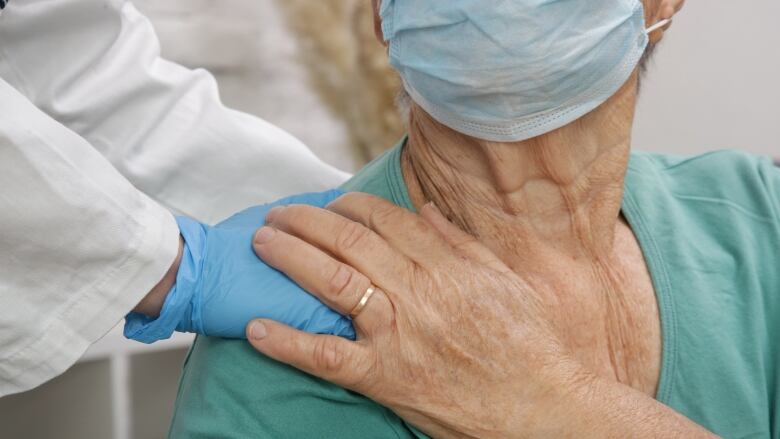 Portrait of elderly caucasian woman wearing protective medical mask.