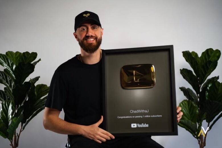 A young man with a Youtube play button, framed.