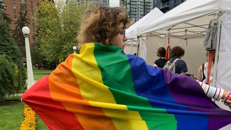 A person is seen holding a brightly colored flag.