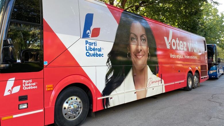 A Liberals campaign bus is parked outside. 