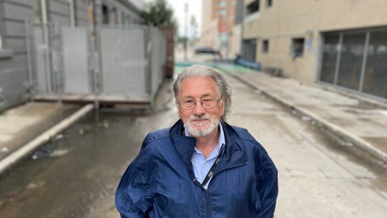 A man stands on a road.