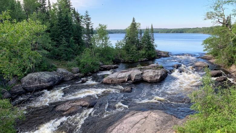 Flowing water goes over rocks.