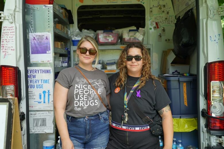 Two women stand in front of a health van in Cambridge, Ont.