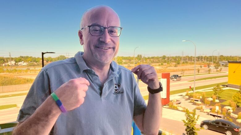 Russ Wyatt smiles and holds up two fists.