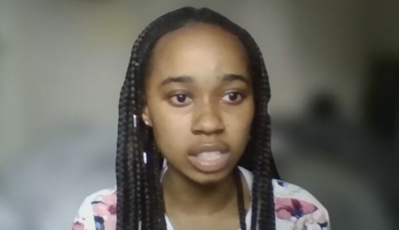 A woman with braids is pictured in a screengrab from a Zoom call.