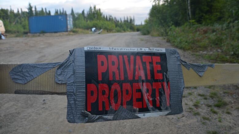 A private property sign is taped to a strap strung across the entrance to the Swan Lake boreal village north of Kirkland Lake. 