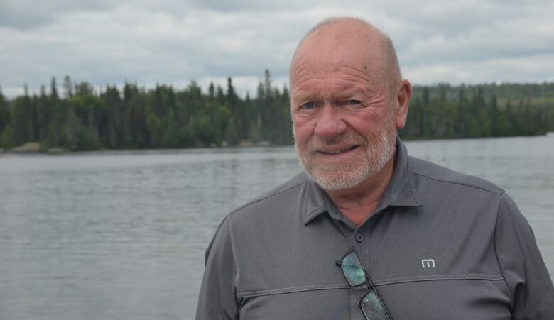 Russell Evans stands at the end of his dock on Kenogami Lake, where his family has owned property for decades. 