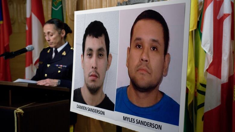 A woman at the podium with poster of the mugshots of two men next to her.