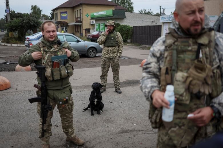 Three soldiers in military fatigues are shown.