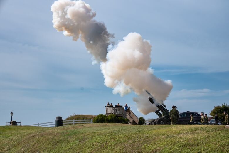 Cannon expels white smoke cloud after soldiers fired it as part of a 21-gun salute. 