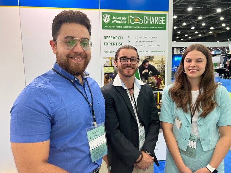 Three university students promoting an exhibit