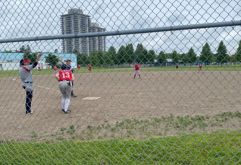 People in softball uniforms on the field.