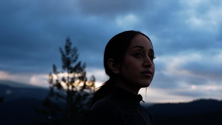 Summan Kandola, a young South Asian woman, is pictured amidst a natural setting.