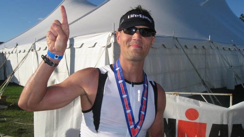 Facebook photo shows a smiling man in running clothes with a medal around his neck.