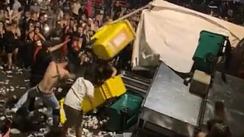 People rioting at a music festival in Vancouver.