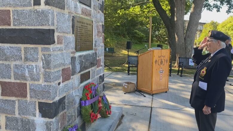 Joyce Pitcher, president of the Bedford Legion, standing in salute before of the cenotaph at a wreath-laying ceremony for Queen Elizabeth II on September 19.