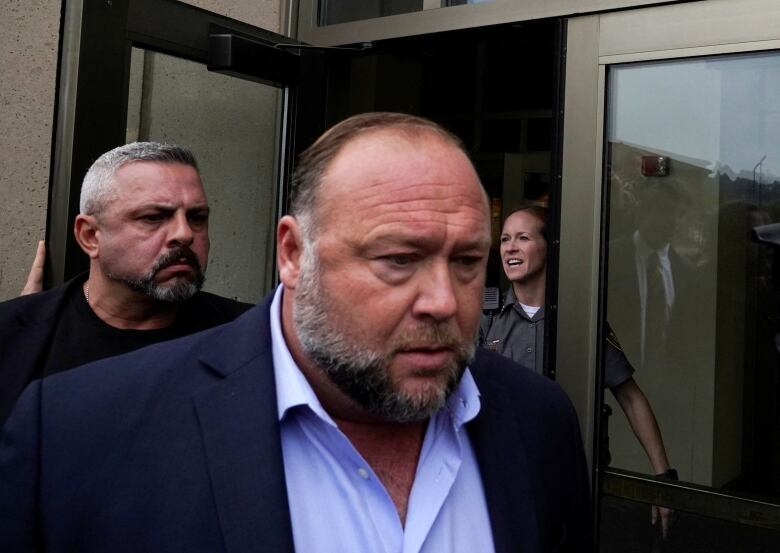 Alex Jones arrives at court for his defamation trial. 