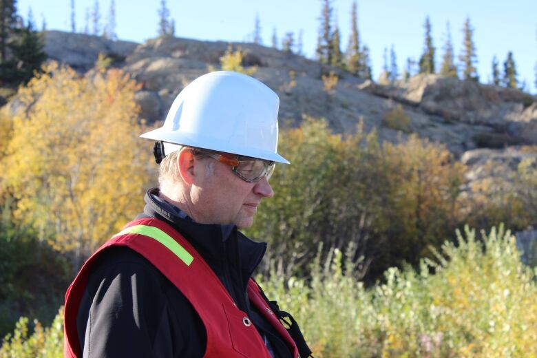 A man with a white hard hat.