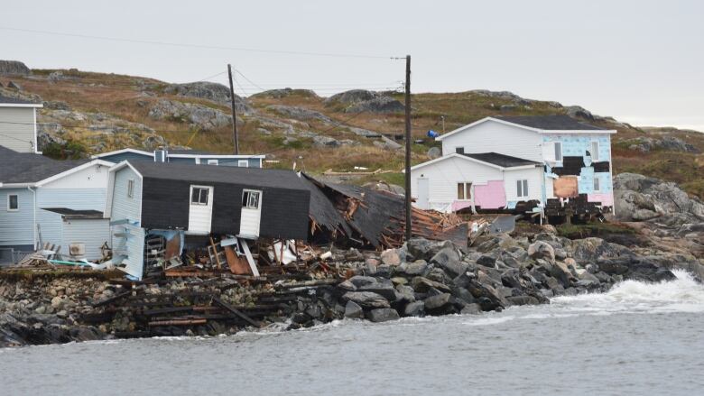 Houses along the coastline damaged by a severe tropical storm.