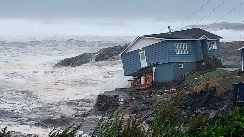 A home fights against high winds caused by post Tropical Storm Fiona. The house would later fall into the ocean.