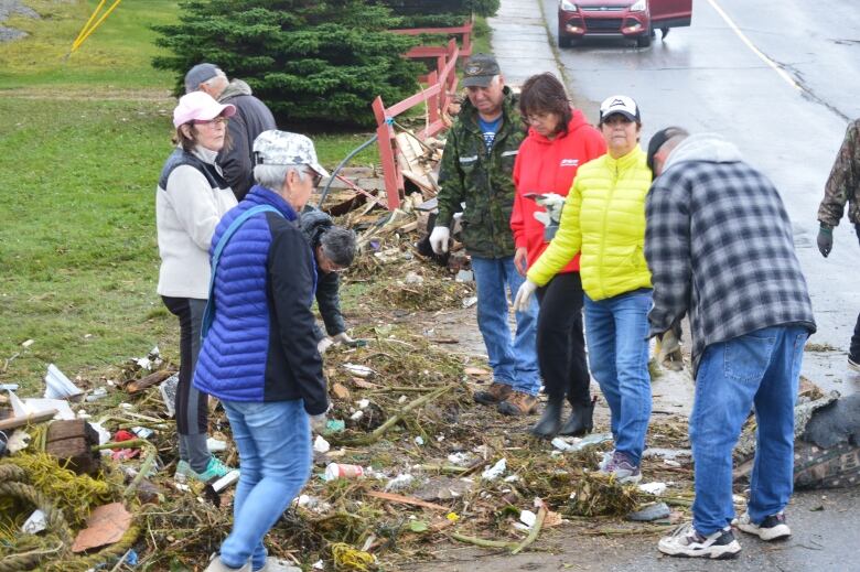 People stand around wreckage