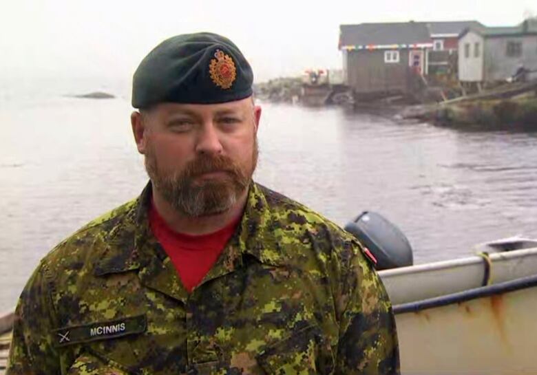 A chest-up shot of a person wearing a camouflage uniform with a nametag that reads 