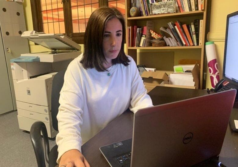 A woman works on a computer.