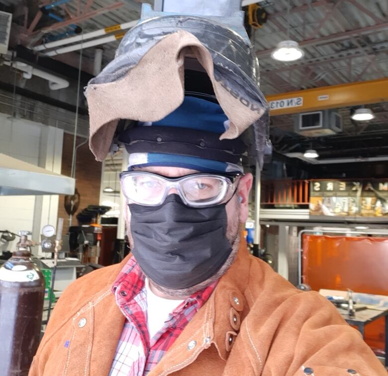 A selfie of a man in welding gear. 