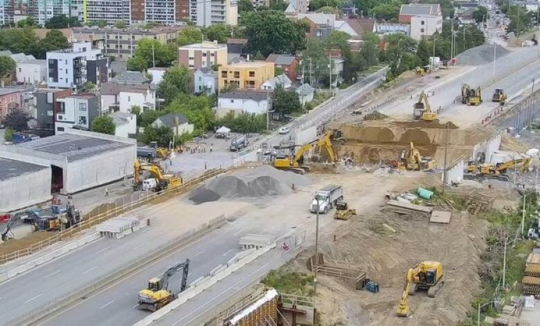 A view from above as heavy equipment takes down a highway bridge.