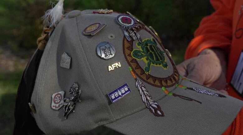 Decontie's hat filled with tokens from those who have helped him get to where he is today.