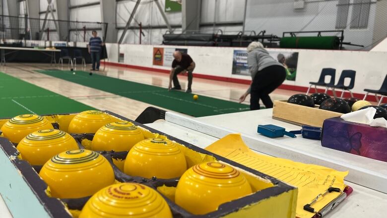 yellow balls and shuffleboard in the back