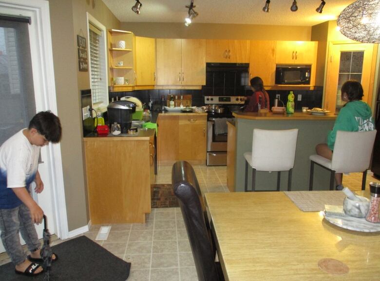 The family in the kitchen of their Taradale rental home.