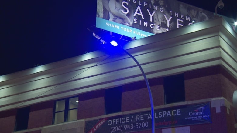 A purple light in front of an office building.