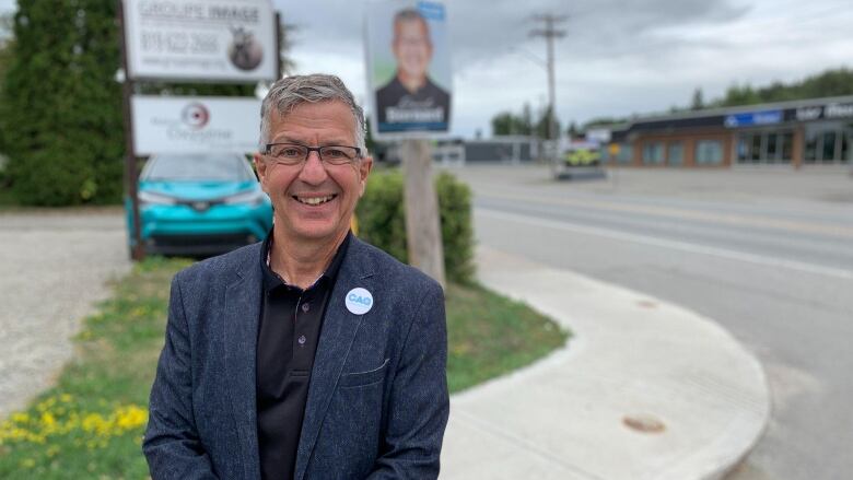 A man standing outside and smiling.